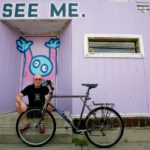 Alex with his bike and Chank art in the background