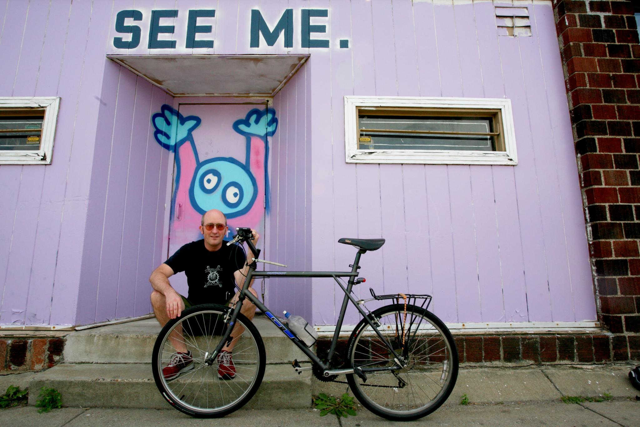 Alex with his bike and Chank art in the background