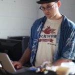 A man working, looking at a laptop