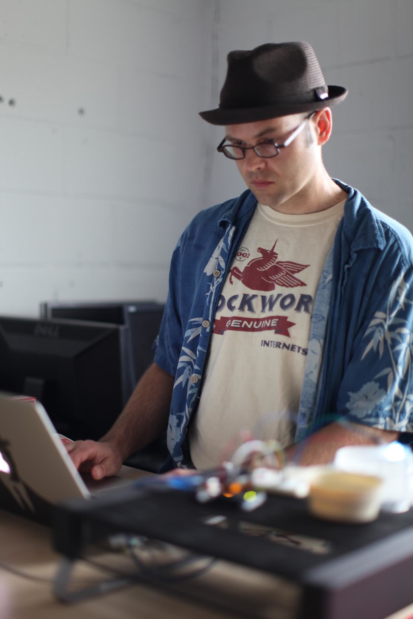 A man working, looking at a laptop