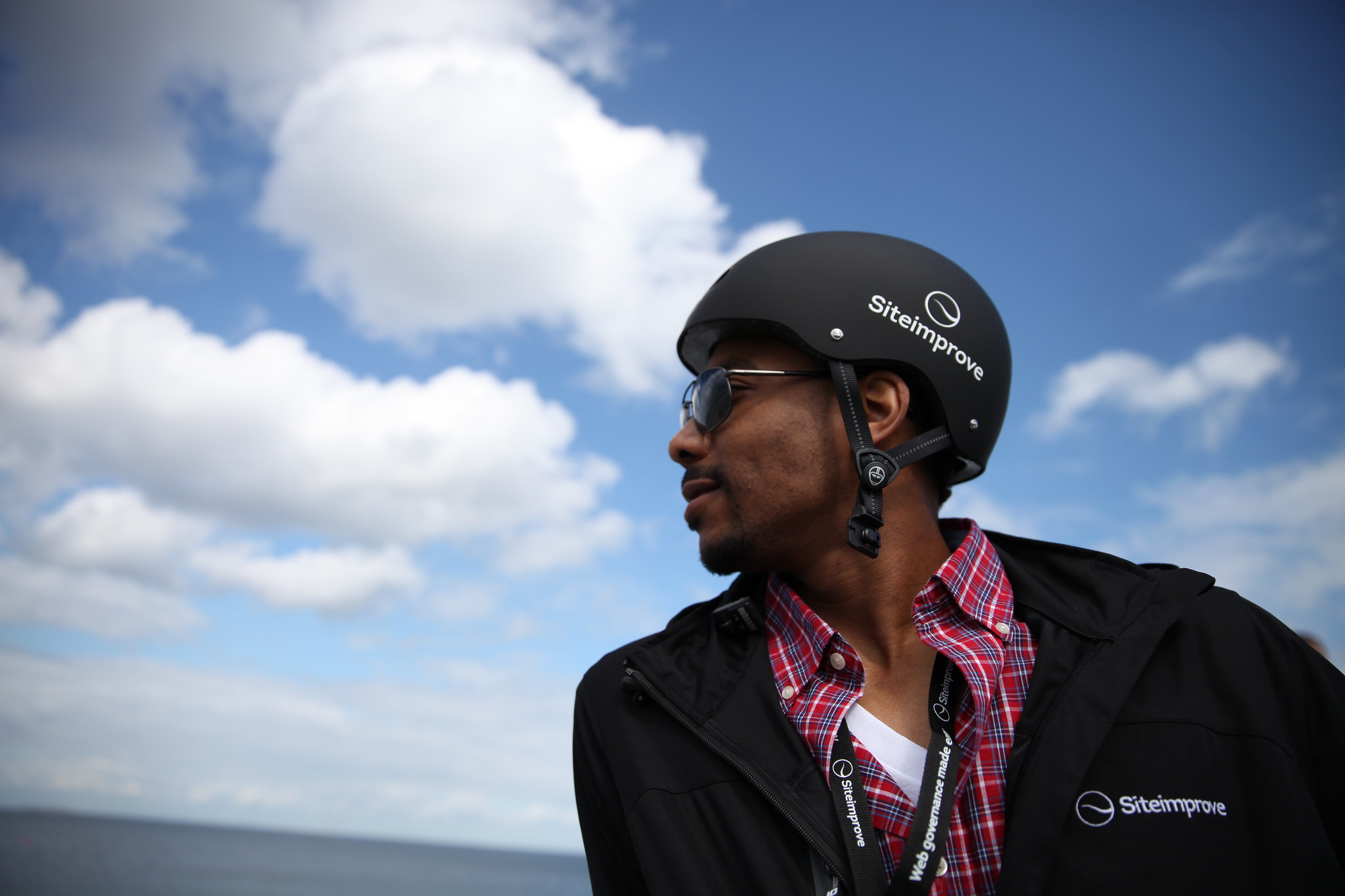 Siteimprove employee wearing branded bike helmet on GAAD 2015