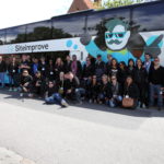 Group of Siteimprove employees posing in front of branded bus on GAAD 2015