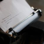 anachronistic typewriter with lines of code