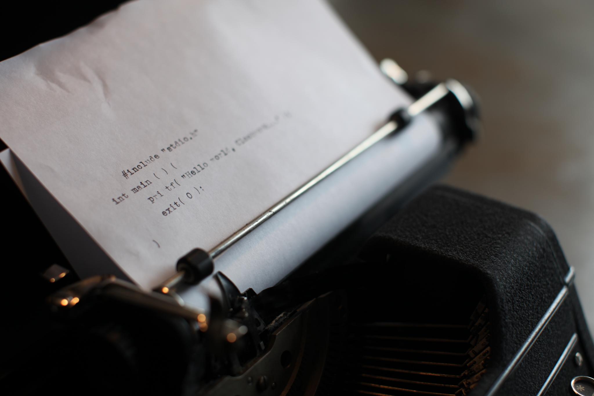 anachronistic typewriter with lines of code
