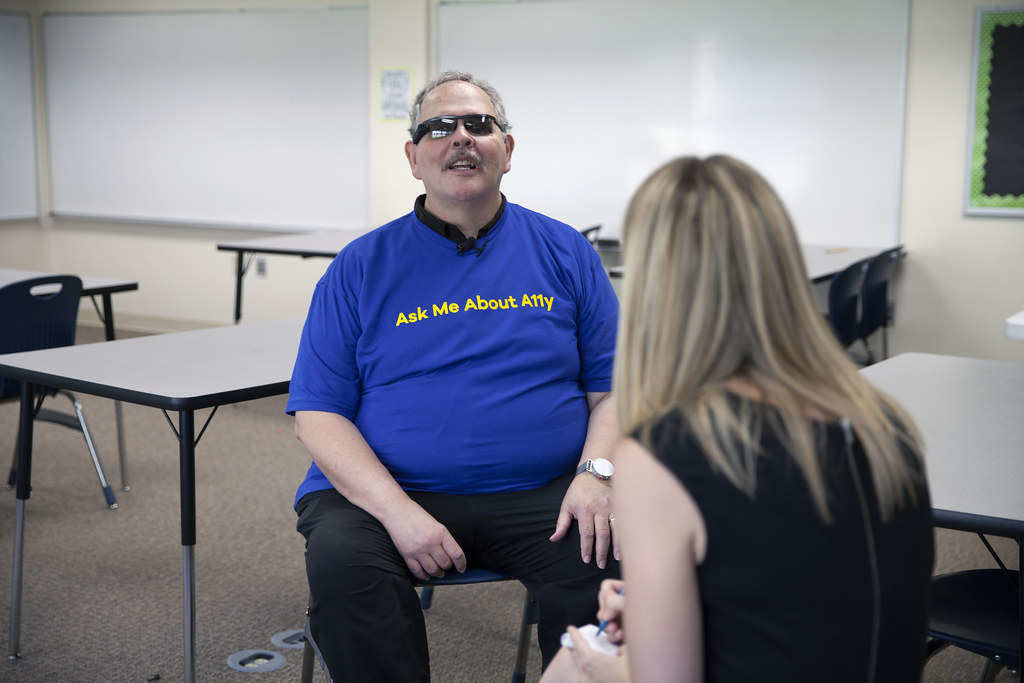 My former colleague, Keith Bundy, wearing a t-shirt with the words Ask Me About A11y for GAAD 2018, while being interviewed by a reporter