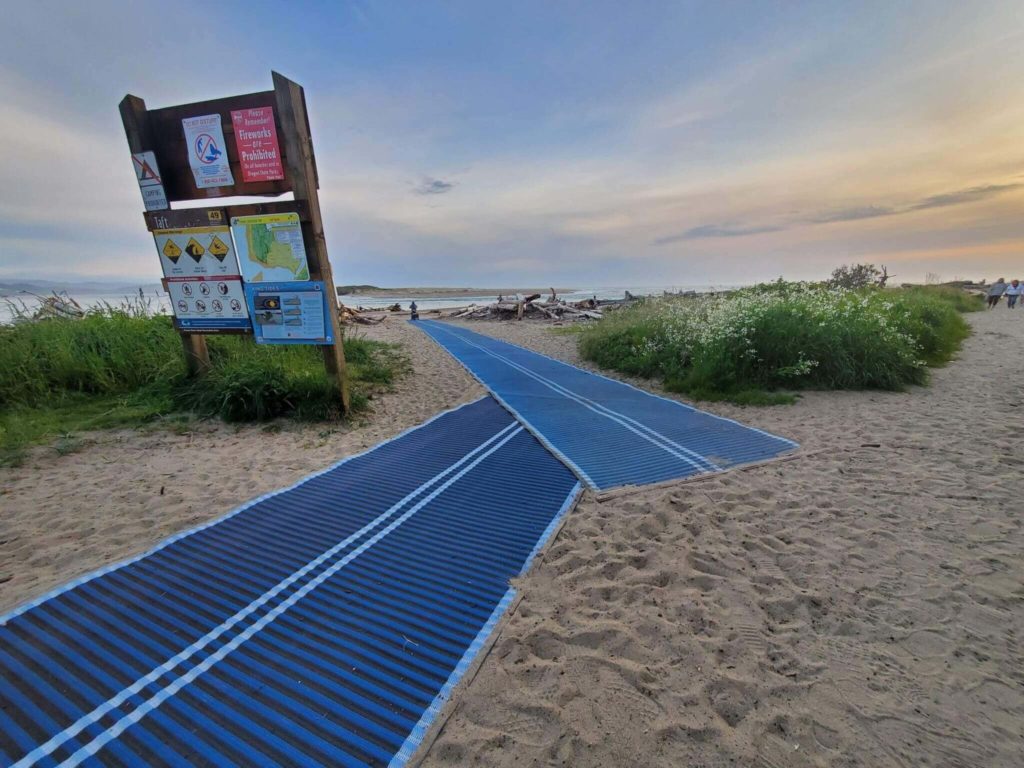 A beach in Lincoln City, Oregon with roll-out pathways with free beach wheelchairs