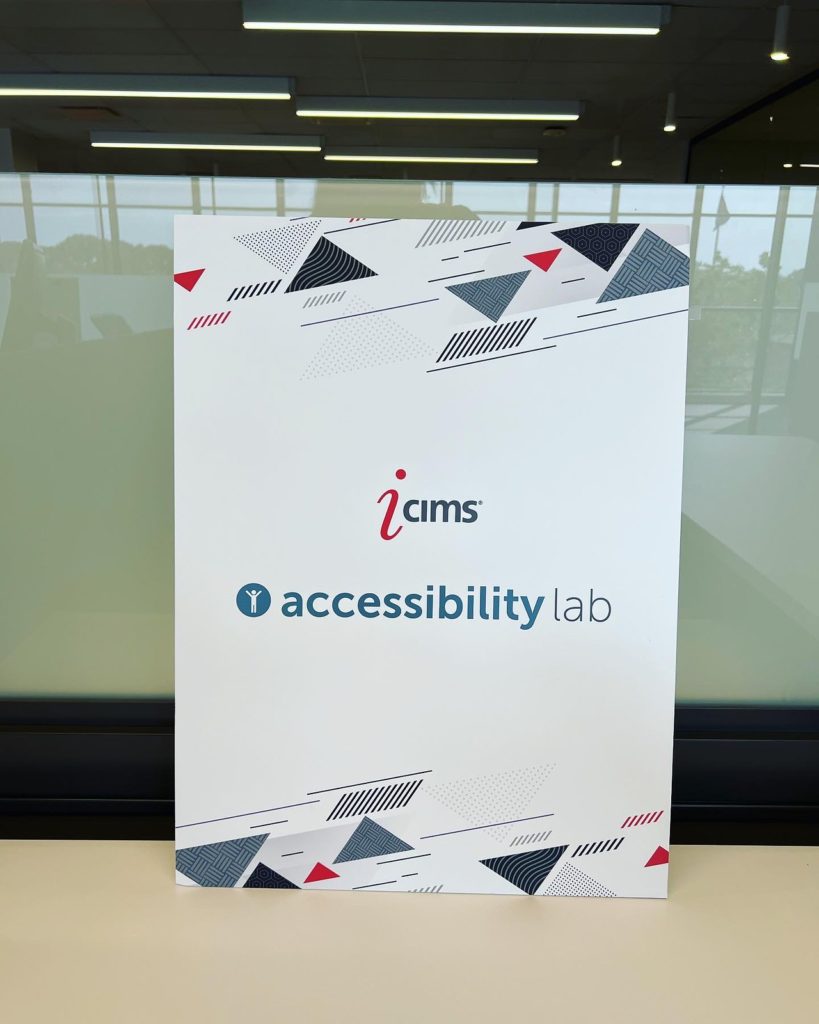 A sign in a cubicle reading icims accessibility lab