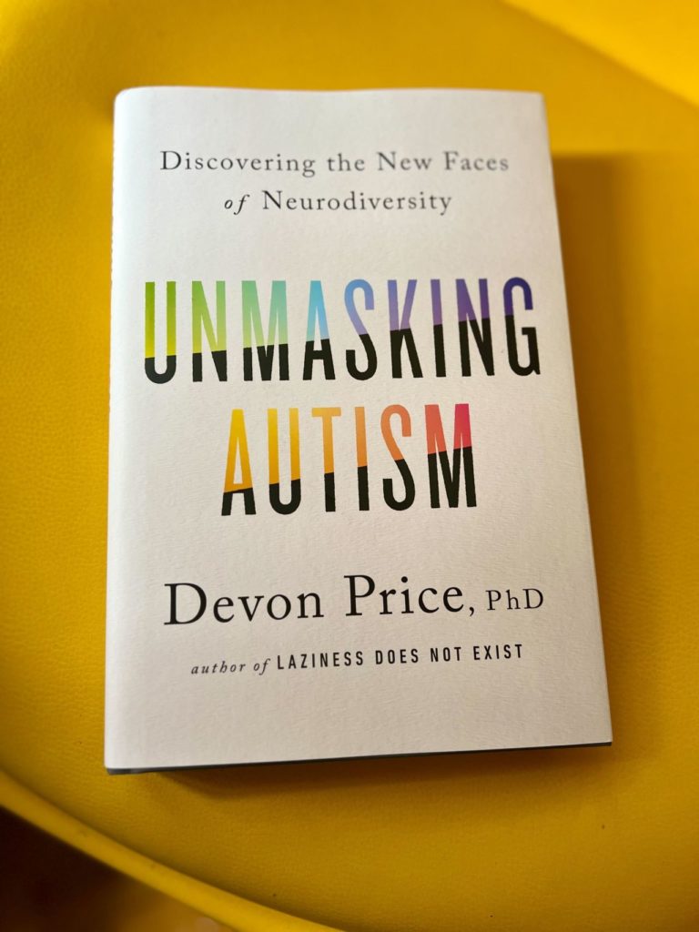 A book resting on a yellow chair. The cover reads Discovering the New Faces of Neurodiversity, Unmasking Autism by Devon Price, PhD, author of Laziness Does Not Exist