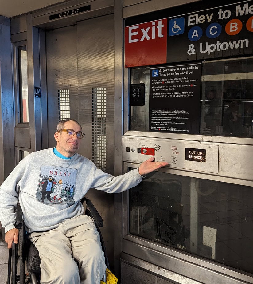 Sasha Blair-Goldensohn, the wheelchair user making Google Maps more accessible, positioned near a NYC subway elevator with a sign indicating it is out of service